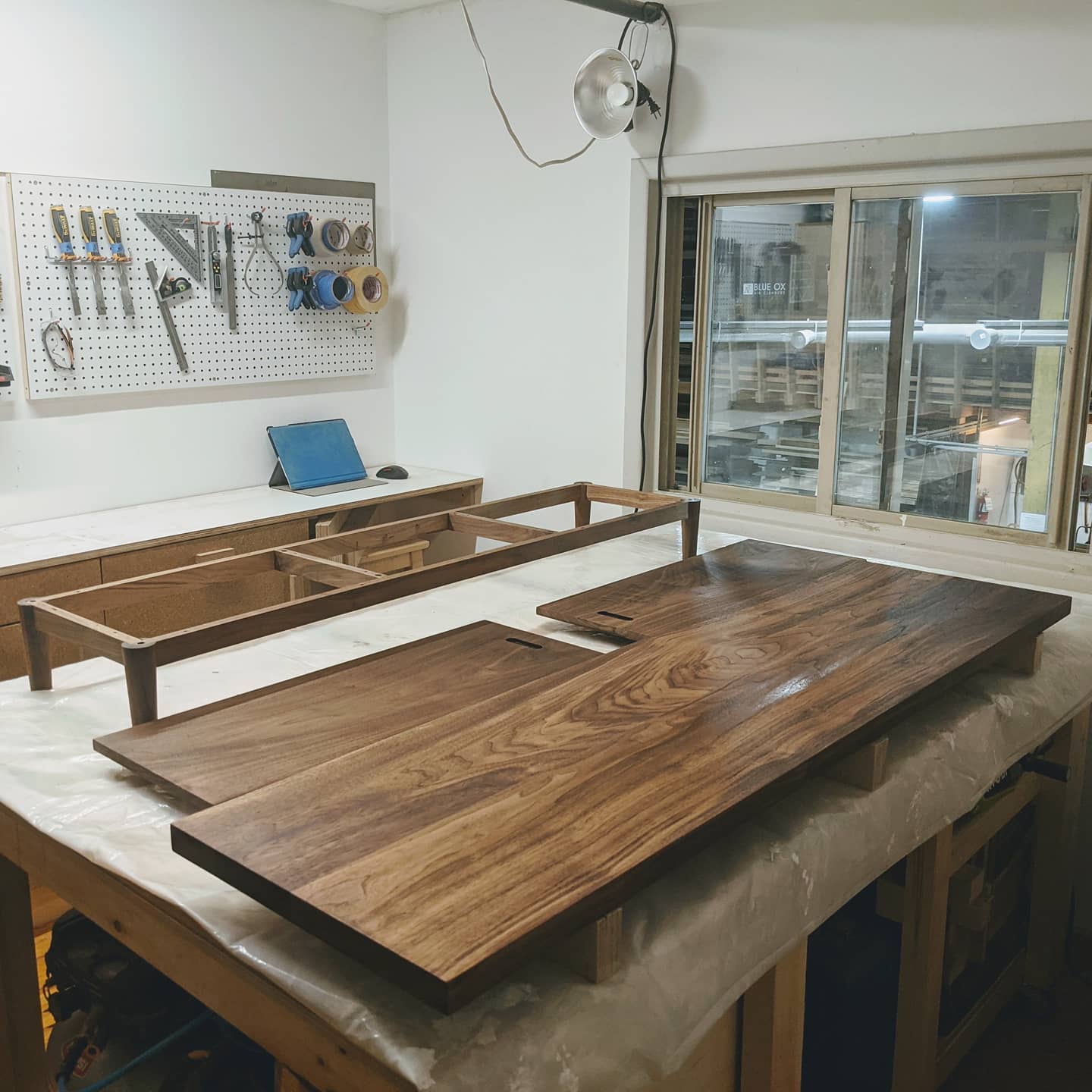 December 5th, 2020: Our studio has been transformed into a finishing room as we apply the first coat of polyurethane to the walnut console's top, doors, and legs! Finished photos will be coming soon!